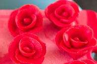 Quickly arranged red marzipan roses.